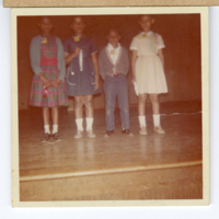 MAF0425_photograph-of-four-students-on-stage-in-the-1963.jpg